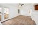 Inviting living room with neutral carpet, ceiling fan, large windows, and access to a balcony at 1333 E Morten Ave # 230, Phoenix, AZ 85020