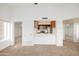 Bright living room with neutral carpet, leading to an open kitchen area with stainless steel appliances at 1333 E Morten Ave # 230, Phoenix, AZ 85020