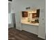 Bright living space showcases a breakfast bar, dark wood cabinets, and modern appliances, offering comfort and style at 1333 E Morten Ave # 230, Phoenix, AZ 85020