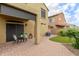 Charming back patio with brick pavers, covered seating area, and small lawn for relaxing and entertaining outdoors at 1350 S Greenfield Rd # 1125, Mesa, AZ 85206