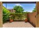 Private backyard featuring a brick-paved patio, green landscaping, and a sense of seclusion, perfect for relaxing outdoors at 1350 S Greenfield Rd # 1125, Mesa, AZ 85206