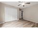 Clean bedroom with wood-look floors, white sliding-door closet, and neutral walls at 1350 S Greenfield Rd # 1125, Mesa, AZ 85206
