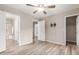 Spacious bedroom boasting wood-look flooring, a ceiling fan, and access to a bathroom and bedroom at 1350 S Greenfield Rd # 1125, Mesa, AZ 85206