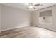 Light-filled bedroom with wood-look floors, a ceiling fan, and a window letting in natural light at 1350 S Greenfield Rd # 1125, Mesa, AZ 85206