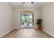 Bedroom with wood-look flooring, ceiling fan, and sliding glass door leading to the home's outdoor space at 1350 S Greenfield Rd # 1125, Mesa, AZ 85206