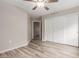 Bedroom featuring wood-look flooring, a ceiling fan, and a sliding-door closet for storage at 1350 S Greenfield Rd # 1125, Mesa, AZ 85206