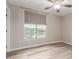 Neutral bedroom showcasing a ceiling fan, wood-look floors, and a view to the exterior at 1350 S Greenfield Rd # 1125, Mesa, AZ 85206