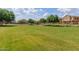Beautiful community park featuring a spacious grassy area, mature trees, and a peaceful setting, ideal for recreation at 1350 S Greenfield Rd # 1125, Mesa, AZ 85206