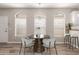 Bright dining area with contemporary chairs, a stylish table, and large windows, perfect for Gathering meals at 1350 S Greenfield Rd # 1125, Mesa, AZ 85206