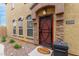 Inviting front door with decorative security screen, well-manicured landscaping, and charming exterior details at 1350 S Greenfield Rd # 1125, Mesa, AZ 85206