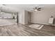 Bright open floor plan with hardwood floors, modern ceiling fan, and adjacent kitchen area at 1350 S Greenfield Rd # 1125, Mesa, AZ 85206