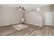 Spacious living room showcasing wood floors, a ceiling fan, and neutral wall color at 1350 S Greenfield Rd # 1125, Mesa, AZ 85206
