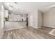 Bright, open living space with hardwood floors, modern lighting, and a view into the kitchen at 1350 S Greenfield Rd # 1125, Mesa, AZ 85206