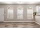 Sunlit living area with hardwood floors, large windows, and a calming neutral color scheme at 1350 S Greenfield Rd # 1125, Mesa, AZ 85206