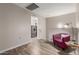 Cozy living space with wood-look flooring, a reading nook, and laundry room access at 1350 S Greenfield Rd # 1125, Mesa, AZ 85206