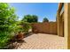Relaxing outdoor patio area featuring lush greenery, potted plants, and a brick-paved surface for comfortable outdoor living at 1350 S Greenfield Rd # 1125, Mesa, AZ 85206