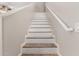 Stylish staircase featuring modern patterned risers and a neutral color palette at 1350 S Greenfield Rd # 1125, Mesa, AZ 85206