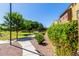 Landscaped community view with walking path, manicured lawn, and neighborhood backdrop on a clear day at 1350 S Greenfield Rd # 1125, Mesa, AZ 85206