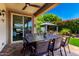 Covered patio with a dining table and a view of the lush backyard and gazebo at 1361 N Claiborne --, Mesa, AZ 85205