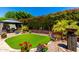 Beautiful backyard featuring a gazebo, manicured landscaping, and vibrant flowers at 1361 N Claiborne --, Mesa, AZ 85205