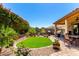 Beautiful backyard featuring an outdoor kitchen, well manicured plants and landscaping, and a covered patio at 1361 N Claiborne --, Mesa, AZ 85205