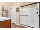 Modern bathroom featuring a glass-enclosed shower with a black frame and wooden-look tile floor at 1361 N Claiborne --, Mesa, AZ 85205