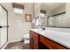 This bathroom features a wooden vanity with sink, toilet, and a large mirror at 1361 N Claiborne --, Mesa, AZ 85205
