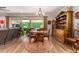 Cozy dining area with backyard views, wood table, and vintage wood display cabinet at 1361 N Claiborne --, Mesa, AZ 85205