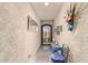 Hallway exhibiting textured walls, decorative masks and wall art, a table, and a carpet at 1361 N Claiborne --, Mesa, AZ 85205