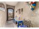 Hallway showcasing textured walls, colorful decorative masks, console table, and carpet at 1361 N Claiborne --, Mesa, AZ 85205