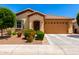 Well-kept single-story home with a desert landscaped front yard and a two-car garage at 1361 N Claiborne --, Mesa, AZ 85205