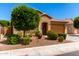Lovely single-story home showcasing a well-manicured front yard and an attached two-car garage at 1361 N Claiborne --, Mesa, AZ 85205