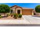 Inviting single-story home showcasing a landscaped front yard and a spacious two-car garage at 1361 N Claiborne --, Mesa, AZ 85205