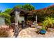 Gazebo features outdoor furniture and shade curtains, surrounded by lush backyard landscaping at 1361 N Claiborne --, Mesa, AZ 85205