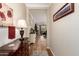 Hallway displaying hardwood floors, a dresser, a table lamp, and a view of the living room at 1361 N Claiborne --, Mesa, AZ 85205