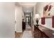 Inviting hallway with wood floors, beautiful decor, and view to the front door and beyond at 1361 N Claiborne --, Mesa, AZ 85205