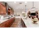 Spacious kitchen with granite counters, stainless hood, cherry cabinetry, and hardwood flooring at 1361 N Claiborne --, Mesa, AZ 85205