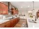 Gourmet kitchen featuring tile backsplash, wood cabinetry, granite counters, and modern appliances at 1361 N Claiborne --, Mesa, AZ 85205