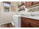 Functional laundry room featuring modern washer/dryer, granite countertop and wood cabinets at 1361 N Claiborne --, Mesa, AZ 85205