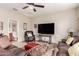 This living room features leather seating, TV, and a view into an attached bathroom at 1361 N Claiborne --, Mesa, AZ 85205