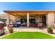Covered patio area with ceiling fans, dining table, seating area, and brick paved flooring at 1361 N Claiborne --, Mesa, AZ 85205