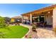 Covered patio features a seating area with a firepit table and an outdoor dining set at 1361 N Claiborne --, Mesa, AZ 85205