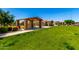 Inviting picnic area with covered seating, surrounded by lush green grass and landscaping at 1361 N Claiborne --, Mesa, AZ 85205