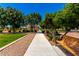 Scenic community walkway lined with trees and manicured landscaping, connecting various amenities at 1361 N Claiborne --, Mesa, AZ 85205