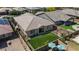 Aerial shot of the backyard with artificial grass, covered patio, and outdoor dining area at 14634 W Wethersfield Rd, Surprise, AZ 85379