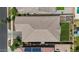 Aerial view of the roof of the home, backyard with pergola, and solar panels at 14634 W Wethersfield Rd, Surprise, AZ 85379