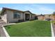 Backyard featuring artificial turf, patio and block fence at 14634 W Wethersfield Rd, Surprise, AZ 85379