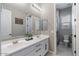 Bathroom features double vanity, decorative mirrors, and a separate toilet room at 14634 W Wethersfield Rd, Surprise, AZ 85379