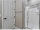 Bathroom with clear glass shower stall and a white door at 14634 W Wethersfield Rd, Surprise, AZ 85379
