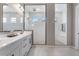 Modern bathroom with double vanity, sleek fixtures, and a frameless glass shower at 14634 W Wethersfield Rd, Surprise, AZ 85379